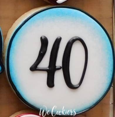 A round cookie with '40' written on it using a PICO projector for cookies
