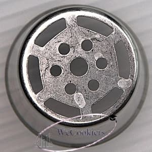 The image shows a Russian piping tip. When you see holes in the middle of these, that means they are representative of and will pipe stamens. This is a cue to make the middle a different color.