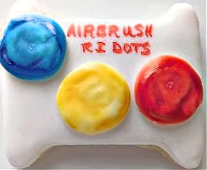 Airbrushed royal icing dots, made using a royal icing transfer sheet. Let them dry well after piping, then airbrush the before peeling the transfers off. Airbrushed royal icing dots, made using a royal icing transfer sheet