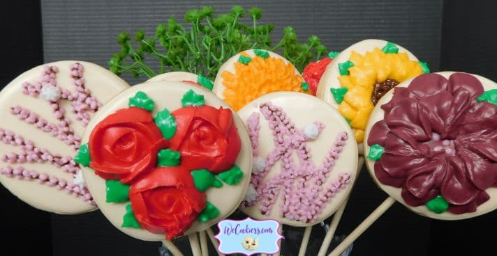 This edible bouquet shows many flowers used in different ways. Photo of cookies on a stick made into a floral bouquet