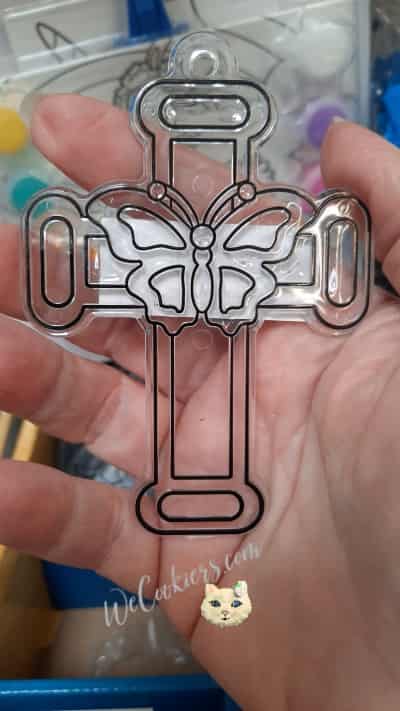 This plastic suncatcher from Walmart made the perfect cross cookie for a baptism. Decorate with your hearts delight! Image of a suncatcher from Walmart. Used to impress shape in dough before baking.