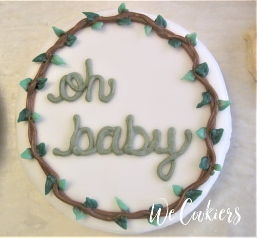 Baby shower cookie with border Plain white round cookie with a woody- leafed boarder