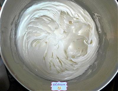 This image shows the finished product after mixing up the royal icing recipe. Beautiful peaks. Royal icing in stainless steel bowl