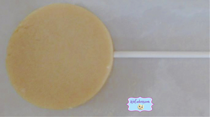 Slide in the treat stick after you have made the hole with a wooden skewer. After making the hole with a skewer, place the stick in the sugar cookie.