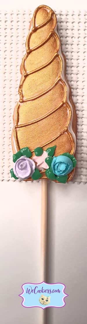 Decorated unicorn horn on a cookie image.