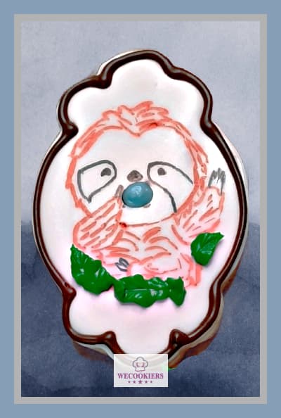 Want an easy way to make sloth cookies for a baby shower? I used food color markers to draw it on and piping a blue pacifier for depth. See more ideas & techniques: Baby boy shower cookies. This cute baby sloth was simply drawn on using a food color marker with a border around the cookie.