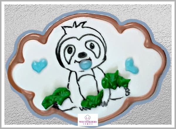 Be simple, yet effective. Draw on your images with food color markers like I did, or watercolor them instead. Pop a pacifier on for depth. See more ideas: I used food color markers to draw a sweet sloth for this baby boy shower cookie. A piped pacifier in its mouth was added for depth.
