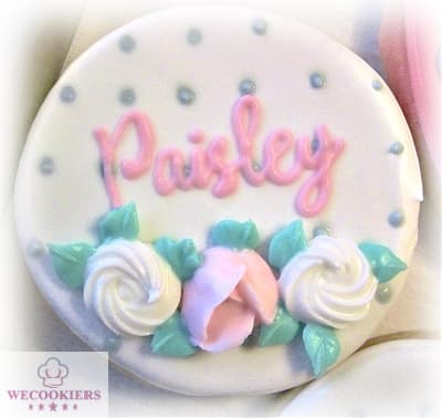 Wet-on-wet technique for this baby girl shower cookie with piped flowers. A cookie projector was used for the name. See more ideas, techniques, popular cutters, & RI transfer templates for babies: