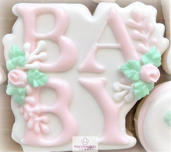 This cutter is shaped to hold the capital letters 'BABY'. Leaves and floral accent it. The word baby is piped in pastel pink on top of a dried white flood. Very popular, this bow cutter is the ultimate for baby girl shower cookies. Versatile, you can add your colors and flowers. More popular cutters, ideas, & RI transfers for babies here: