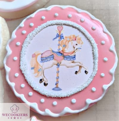 This carousel horse cookie is an edible image with borders and white sanding sugar placed on a pink flooded cookie. You can save loads of time making girl baby shower cookies with edible images and have them look professional too. More ideas, techniques, popular cutters, & RI transfer sheets for baby cookies: