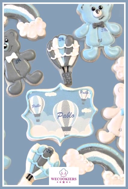 This precious little set of baby boy cookies was decorated in light navy blue, white, and gray. I used an edible image for the baby's name. Visit for more: Baby boy shower cookies in light navy, white, and gray. This is a hot air balloon and rainbow theme with teddy bears. The name plaque is an edible image.