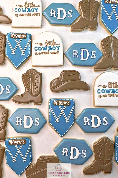 Loved decorating this set of baby cookies for a boy. Don't have a pocket cutter? Cut off the bottom sides of a rectangle. More ideas here: This theme of decorated baby shower cookies is for a boy, "A little cowboy is on the way". Shapes are a blue jean pocket, long diagonals with initials, cowboy boots, and cowboy hat.