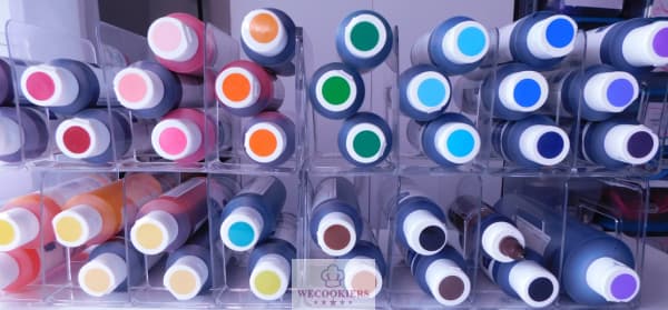 I use Americolor food color gels. I have them displayed for easy color viewing in closet organizers from Amazon. See more: Food color gels in closet organizers to see colors instantly.