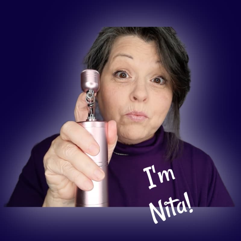 Photo shows Nita, owner of WeCookiers.com holding a cordless airbrush.