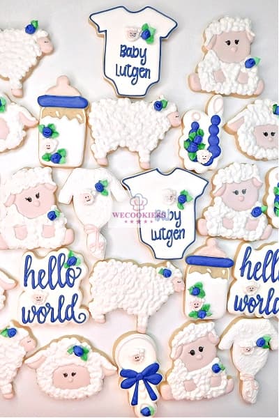 Love these baby shower cookies for a boy? Be sure to catch the WeCookier's video on the making of the entire set at: This image depicts a set of sheep-themed baby boy cookies done in royal blue and white, as the customer requested.