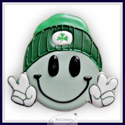This photo shows one of my new cutters for Saint Patricks Day sugar cookies. It is of a light green emoji smiling with a green stocking cap and both thumbs up. Adorable!
