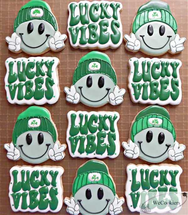 These Saint Patricks Day sugar cookies are of a 'Lucky Vibes' and a hipster smiling emoji cookie set.