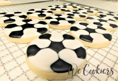 Fully decorated finished cookies Finished, last stage, of fully decorated soccer balls.