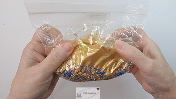 Changing colored sprinkles into gold sprinkles for sugar cookies.