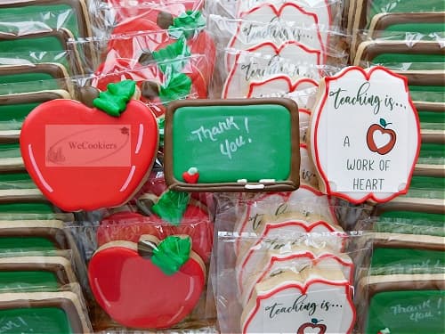The 'Thank You' was written on my a white food color marker. The teacher quote is an edible image that can be downloaded or bought through here: https://www.wecookiers.com/food-color-markers.html This image is of a teachers cookie set. The chalkboard decorated sugar cookie says 'Thank you" and is written with a white food color marker.